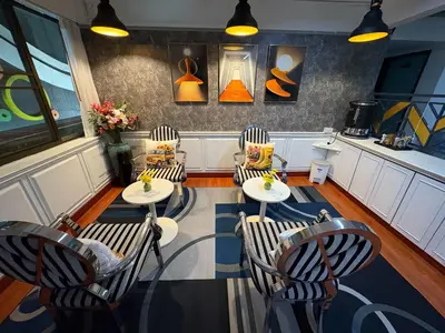 a restaurant with three chairs and tables in a room at Wow Guesthouse in Bangkok