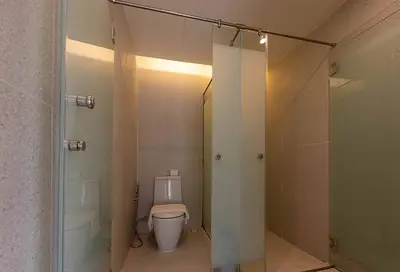 a bathroom with a toilet and a walk in shower at Boxpackers Pratunam in Bangkok