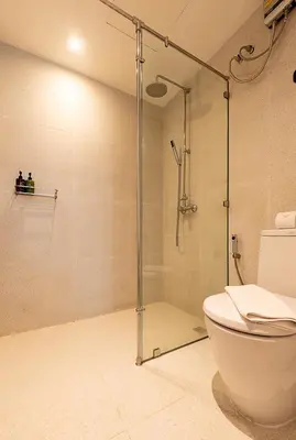 a bathroom with a shower and a toilet at Boxpackers Pratunam in Bangkok