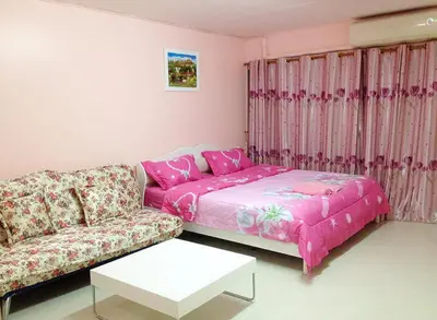 a living room with a couch and a table at SK Muang Thong Thani in Bangkok