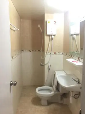 a bathroom with a toilet and a sink at SK Muang Thong Thani in Bangkok
