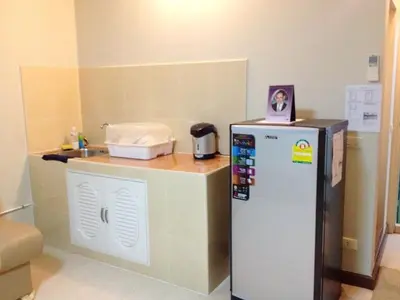 a small kitchen with a refrigerator and a sink at SK Muang Thong Thani in Bangkok