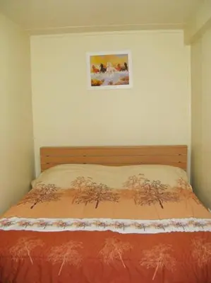 a bed in a bedroom with a picture on the wall at SK Muang Thong Thani in Bangkok