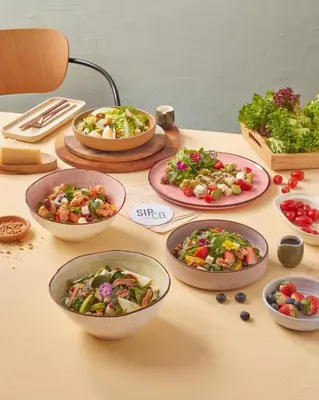 a table topped with bowls of different types of food at Sindhorn Midtown Hotel Bangkok, Vignette Collection by IHG in Bangkok
