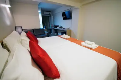 a bedroom with a large bed with red pillows at Wild Orchid Villa Bangkok in Bangkok