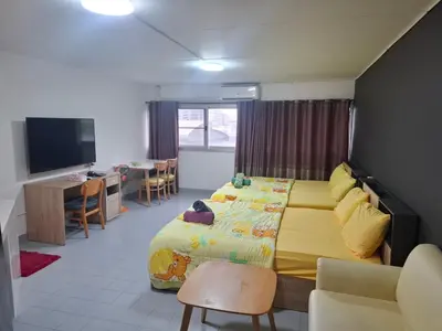 a bedroom with a bed and a desk and a television at K.NAT Room service in Nonthaburi