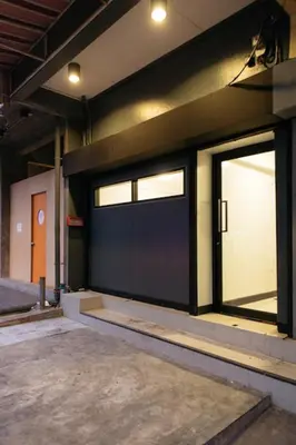a garage with two sliding glass doors on a building at T2 2 Bedrooms 6 guests Full kitchen 1 min to BTS in Bangkok