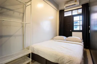 a small bedroom with a bed and a window at T5 2 Bedrooms/6guests/full kitchen/1 min to BTS in Bangkok