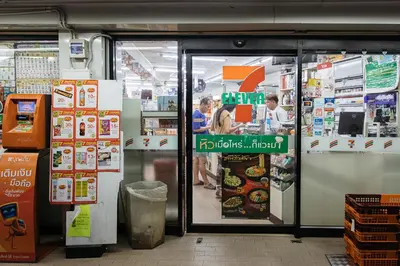 a store entrance with people ordering food in a store at B2 Large + Comfort full kitchen near MRT Bangson in Bangkok