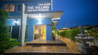 a building with a sign that reads the walking hotel and residence at The Willing Hotel and Residence in Lak Si