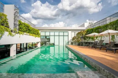 a swimming pool in the middle of a building at Amanta Hotel & Residence Sathorn in Bangkok