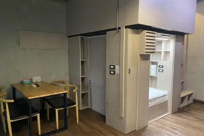 a small room with a table and a dining room at 44 Room Rama 3 in Bangkok