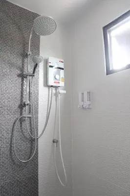 a shower with a shower head in a bathroom at 44 Room Rama 3 in Bangkok