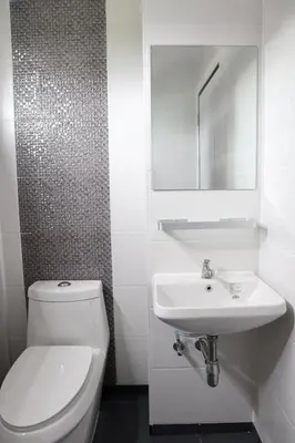 a white bathroom with a toilet and a sink at 44 Room Rama 3 in Bangkok