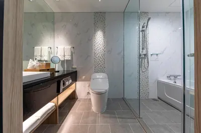 a bathroom with a toilet and a sink and a tub at Solaria Nishitetsu Hotel Bangkok in Bangkok