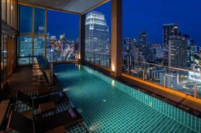 a swimming pool on top of a building with a city skyline at Solaria Nishitetsu Hotel Bangkok in Bangkok