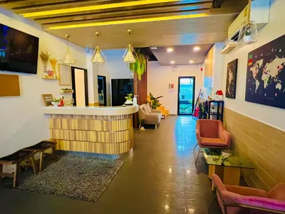 a lobby with a bar in the middle of a room at Daraya Hostel in Bangkok