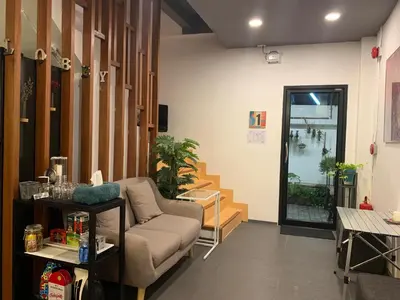 a living room with a couch and a table at Daraya Hostel in Bangkok