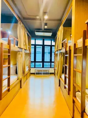 a room with multiple bunk beds in a building at Daraya Hostel in Bangkok