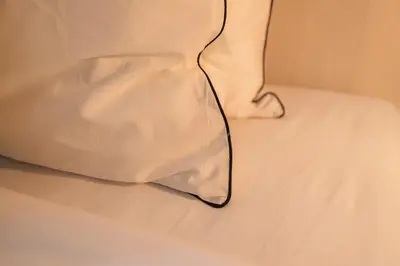 a white pillow sitting on top of a bed at MIQ Asoke808 Villa - Asoke BTS - garden pool - 16 Pax in Bangkok