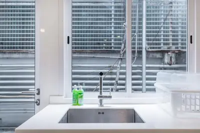 a kitchen counter with a sink and a window at MIQ Asoke808 Villa - Asoke BTS - garden pool - 16 Pax in Bangkok