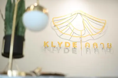 a sign on a wall with an umbrella on it at KLYDE Boutique - Chatuchak in Bangkok