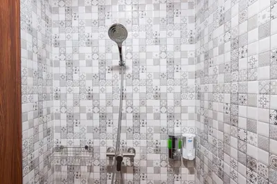 a bathroom with a shower with a shower head at Mangkon Hostel in Bangkok