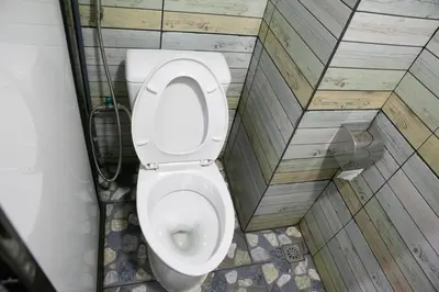 a bathroom with a toilet in a stall at Bangkok Canale Home at Khaosarn in Bangkok