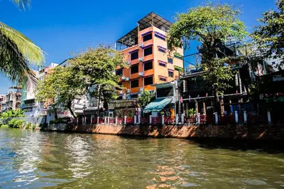 a river with a building on the side of it at Bangkok Canale Home at Khaosarn in Bangkok