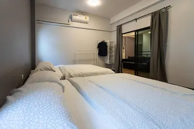 a bedroom with two beds and a window at U3 Large 2 Bedroom Full kitchen near BTS Udomsuk in Bangkok