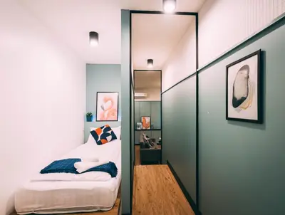 a bedroom with a mirror and a bed in it at Saffron Hill Bangkok in Bangkok