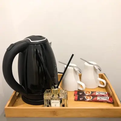 a black tea kettle on a wooden tray at Saffron Hill Bangkok in Bangkok