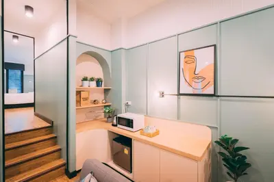 a home office with a desk and a microwave at Saffron Hill Bangkok in Bangkok