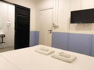 a bedroom with two towels on a bed at Saffron Hill Bangkok in Bangkok
