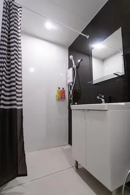 a white bathroom with a shower and a sink at U2 Large 2 Bedrooms 100m to BTS station in Bangkok