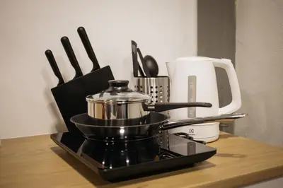 a kitchen counter with a coffee pot and utensils at U2 Large 2 Bedrooms 100m to BTS station in Bangkok
