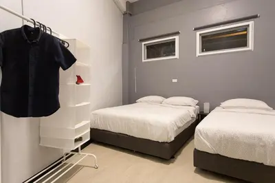 a bedroom with two twin beds and a dresser at U1 Large 2 bed rooms BTS Udomsuk in Bangkok