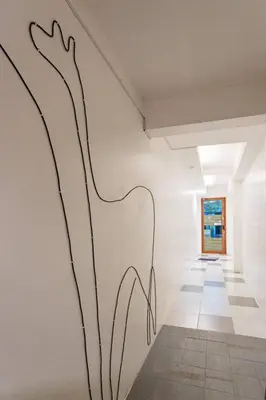 a wall with a painting on it in a hallway at B3 Cosy Studio /5 guests/ Near MRT/full kitchen in Bangkok
