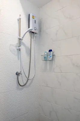 a shower in a bathroom with white tiles at B3 Cosy Studio /5 guests/ Near MRT/full kitchen in Bangkok