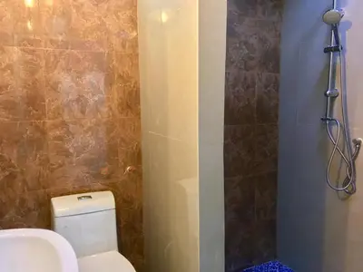 a bathroom with a toilet and a shower at C U Again in Bangkok