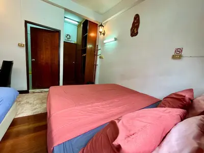 a bedroom with two beds with a red blanket at C U Again in Bangkok