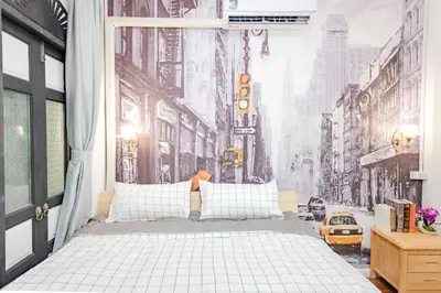 a bedroom with a bed with a city street mural at Mein Haus B @Bangpo in Bang Su