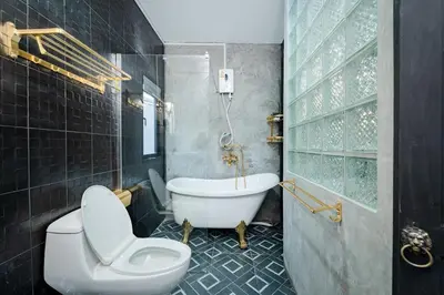 a bathroom with a tub and a toilet and a sink at Mein Haus B @Bangpo in Bang Su