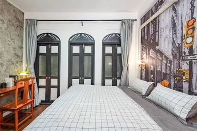 a bedroom with a large bed and windows at Mein Haus B @Bangpo in Bang Su
