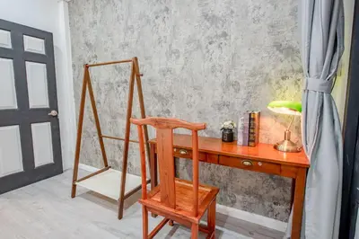 a wooden desk with a chair and a mirror at Mein Haus B @Bangpo in Bang Su