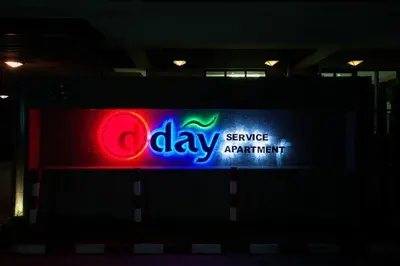 a sign for a serviceagentagent sign at night at D Day Suite in Bangkok
