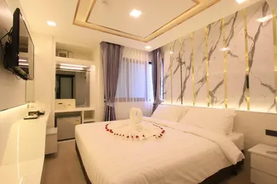 a bedroom with a white bed and a window at Pratunam Atrium Hotel in Bangkok