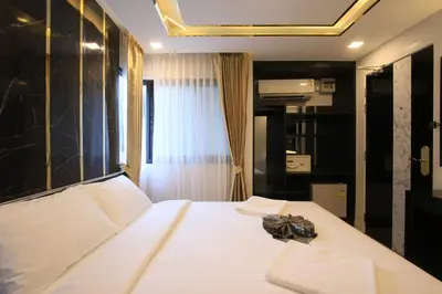 a bedroom with a large white bed in a room at Pratunam Atrium Hotel in Bangkok