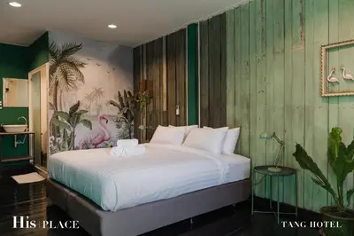 a bedroom with a bed with two towels on it at Tang House in Bangkok