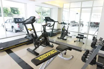 a gym with treadmills and elliptical machines at Lee Garden Bangkok in Bangkok